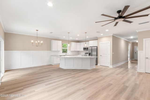 6334 Salado Rd, Saint Augustine, FL 32080 - kitchen with stainless steel appliances, crown molding, a ceiling fan, white cabinets, and open floor plan