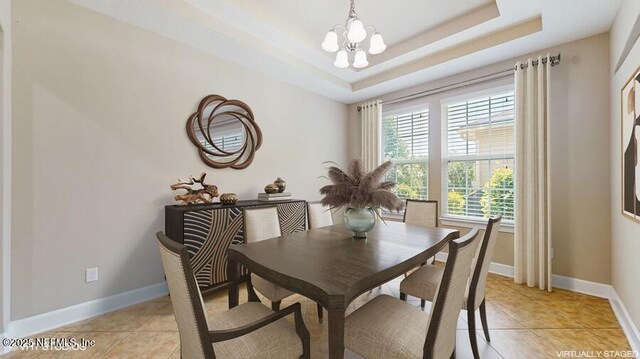 1911 Salt Creek Dr, Fleming Island, FL 32003 - dining area with a chandelier, light tile patterned flooring, and a tray ceiling