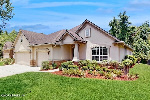 1911 Salt Creek Dr, Fleming Island, FL 32003 - view of front of property with stucco siding, a front yard, concrete driveway, and roof with shingles