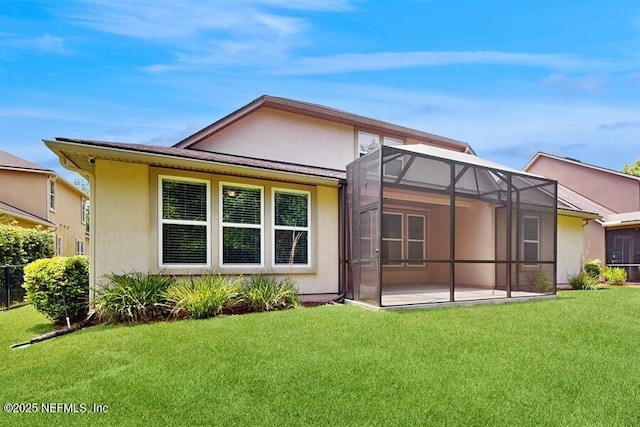 1911 Salt Creek Dr, Fleming Island, FL 32003 - back of house with a lawn, a patio area, stucco siding, and a lanai