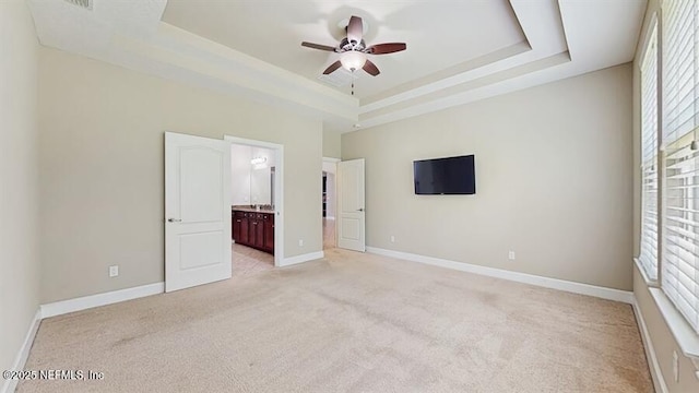 1911 Salt Creek Dr, Fleming Island, FL 32003 - unfurnished bedroom with a raised ceiling, light carpet, ensuite bathroom, and a ceiling fan