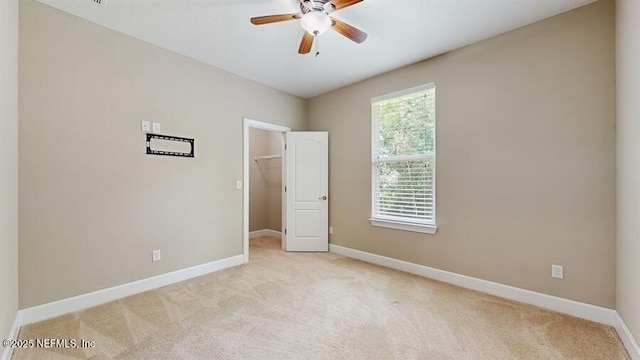 1911 Salt Creek Dr, Fleming Island, FL 32003 - unfurnished bedroom featuring light carpet, a spacious closet, a closet, and a ceiling fan