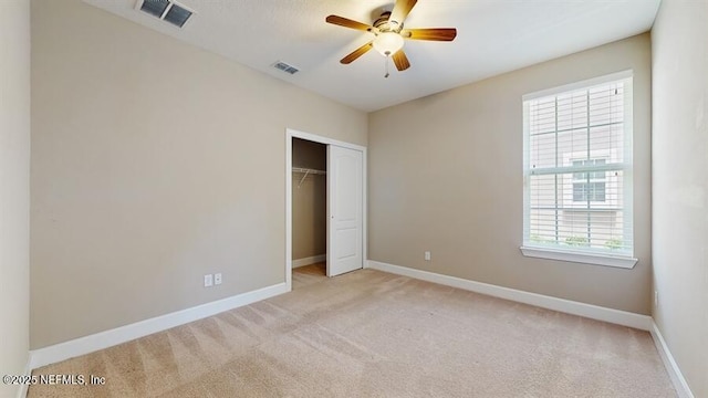 1911 Salt Creek Dr, Fleming Island, FL 32003 - unfurnished bedroom featuring light carpet, a closet, and ceiling fan