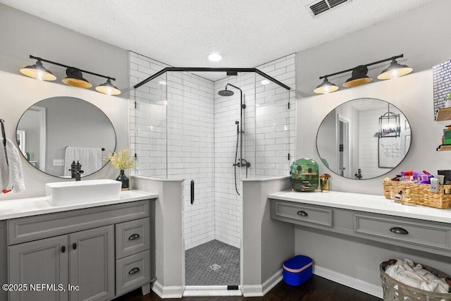 2346 Fairfield Ct, Fleming Island, FL 32003 - bathroom with a textured ceiling, a stall shower, vanity, and wood finished floors