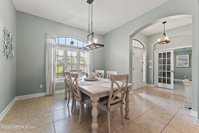 33114 Prairie Parke Pl, Fernandina Beach, FL 32034 - dining area featuring arched walkways, light tile patterned flooring, and a chandelier