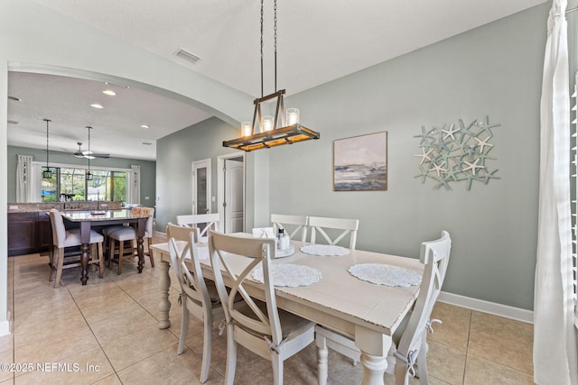33114 Prairie Parke Pl, Fernandina Beach, FL 32034 - dining area featuring arched walkways, recessed lighting, and light tile patterned floors