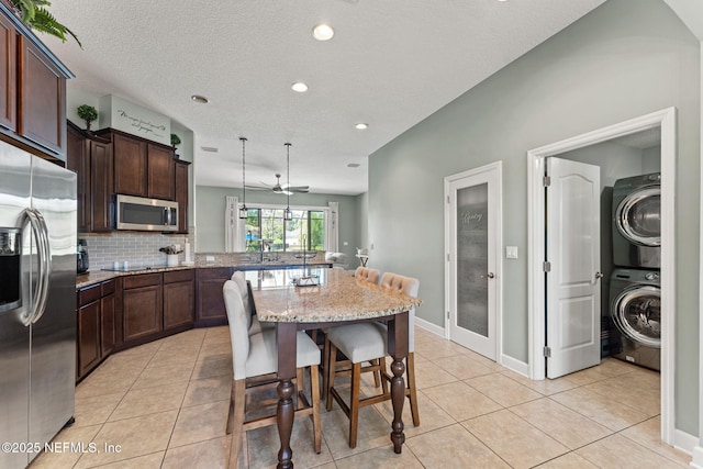 33114 Prairie Parke Pl, Fernandina Beach, FL 32034 - dining room featuring stacked washer / drying machine, light tile patterned flooring, recessed lighting, a ceiling fan, and a textured ceiling