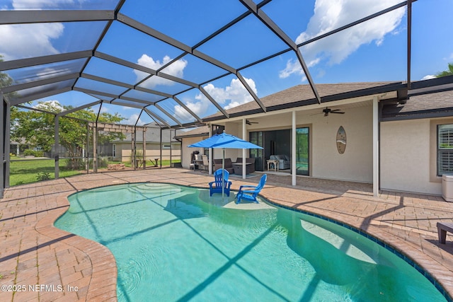 33114 Prairie Parke Pl, Fernandina Beach, FL 32034 - swimming pool with ceiling fan, a patio area, area for grilling, and glass enclosure