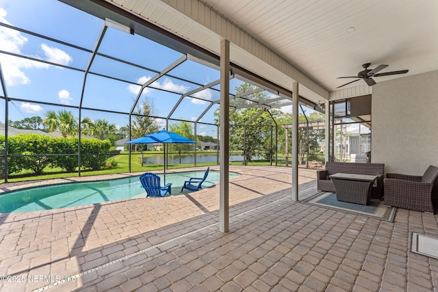 33114 Prairie Parke Pl, Fernandina Beach, FL 32034 - swimming pool featuring a patio area, a water view, glass enclosure, and an outdoor hangout area