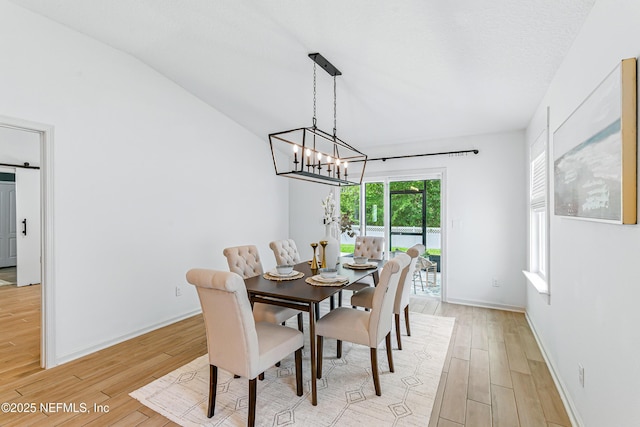 141 Balmoral Castle Dr, Saint Johns, FL 32259 - dining room with light wood-type flooring, a chandelier, and lofted ceiling