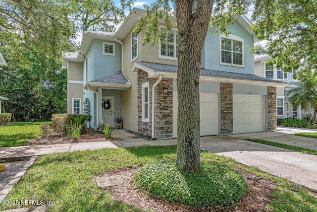 215 Bayberry Cir Unit 601, Saint Augustine, FL 32086 - view of front of house featuring stone siding, a garage, stucco siding, and driveway