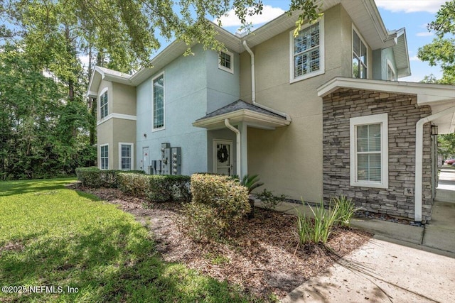 215 Bayberry Cir Unit 601, Saint Augustine, FL 32086 - view of front of house featuring stucco siding, stone siding, and a front yard