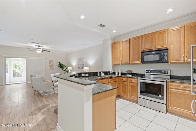 215 Bayberry Cir Unit 601, Saint Augustine, FL 32086 - kitchen with stainless steel electric range oven, black microwave, a peninsula, dark stone counters, and ornamental molding