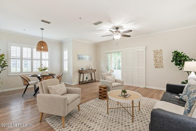 215 Bayberry Cir Unit 601, Saint Augustine, FL 32086 - living room with light wood finished floors, a ceiling fan, and crown molding