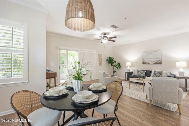 215 Bayberry Cir Unit 601, Saint Augustine, FL 32086 - dining area with light wood-style flooring, crown molding, plenty of natural light, and ceiling fan