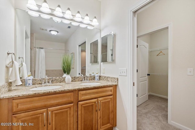 215 Bayberry Cir Unit 601, Saint Augustine, FL 32086 - bathroom with double vanity, a spacious closet, and curtained shower