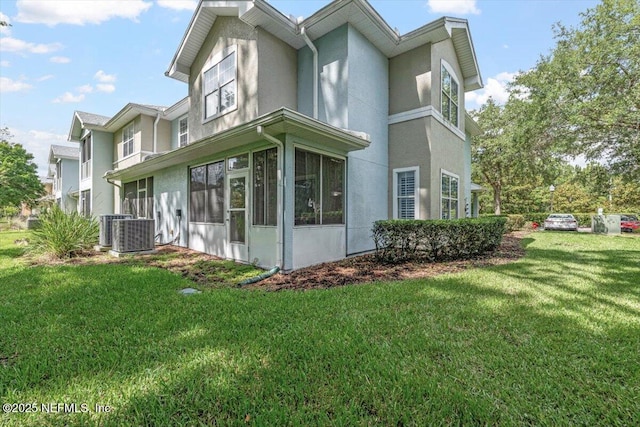 215 Bayberry Cir Unit 601, Saint Augustine, FL 32086 - view of side of home featuring stucco siding, a sunroom, and a lawn