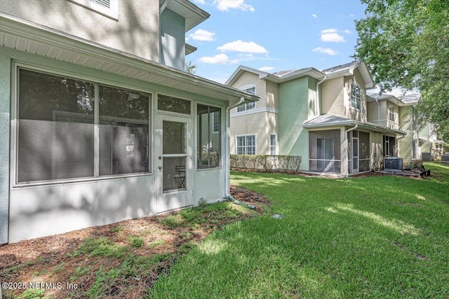 215 Bayberry Cir Unit 601, Saint Augustine, FL 32086 - view of home's exterior with a sunroom, stucco siding, and a yard