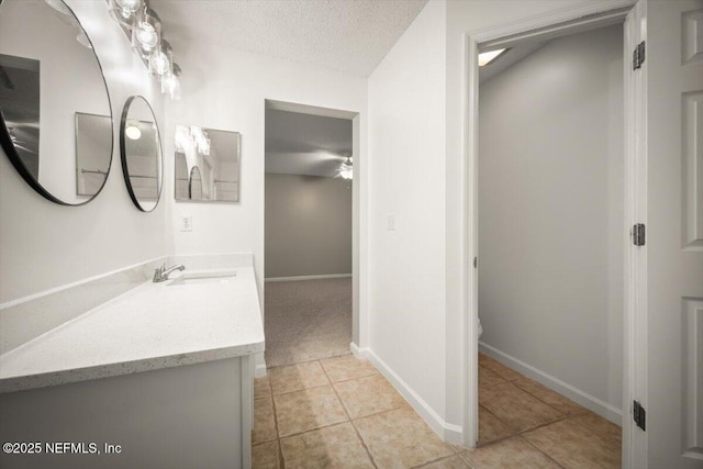 268 Southlake Dr, Saint Augustine, FL 32092 - bathroom featuring vanity, tile patterned flooring, a textured ceiling, and a ceiling fan