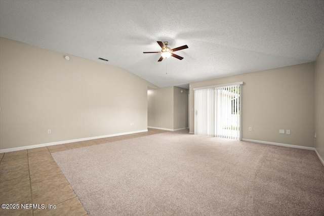 268 Southlake Dr, Saint Augustine, FL 32092 - empty room with ceiling fan, a textured ceiling, tile patterned floors, and vaulted ceiling