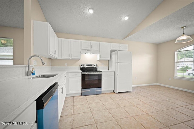 268 Southlake Dr, Saint Augustine, FL 32092 - kitchen featuring appliances with stainless steel finishes, a textured ceiling, light countertops, under cabinet range hood, and white cabinetry