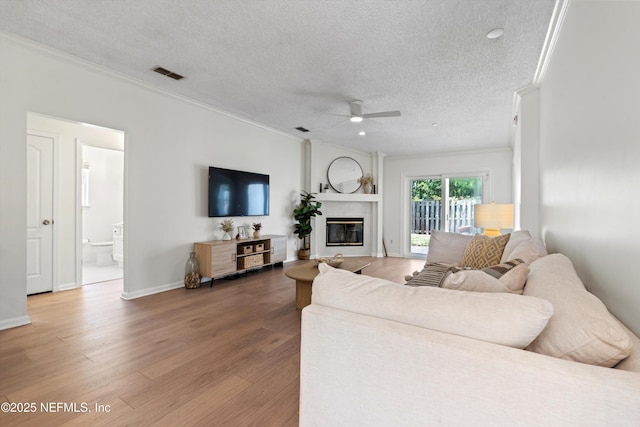 1578 Linkside Dr, Atlantic Beach, FL 32233 - living area featuring crown molding, a ceiling fan, a textured ceiling, wood finished floors, and a high end fireplace