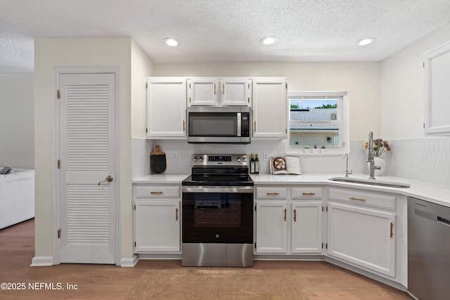 1578 Linkside Dr, Atlantic Beach, FL 32233 - kitchen featuring stainless steel appliances, white cabinetry, light countertops, a textured ceiling, and recessed lighting