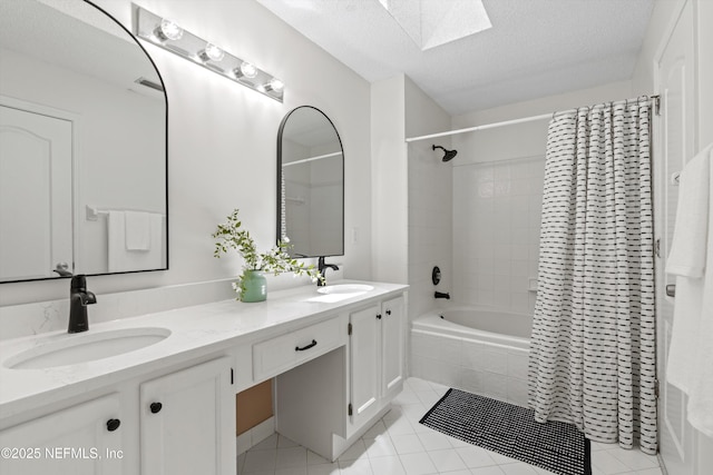 1578 Linkside Dr, Atlantic Beach, FL 32233 - bathroom with a skylight, tiled shower / bath, double vanity, tile patterned flooring, and a textured ceiling