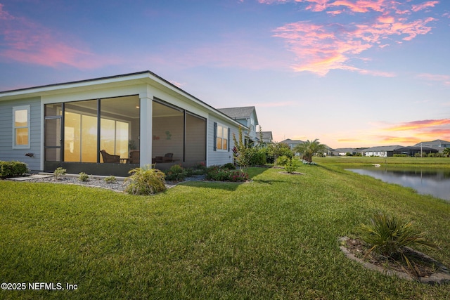 7 Los Lagos Blvd, Palm Coast, FL 32137 - view of green lawn with a water view and a sunroom