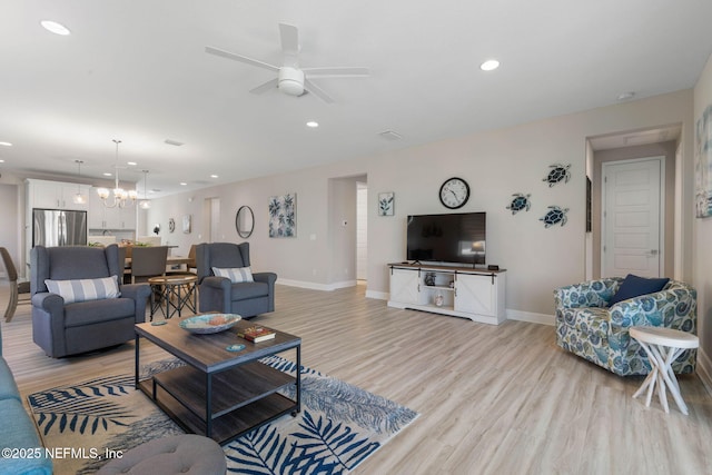 7 Los Lagos Blvd, Palm Coast, FL 32137 - living area featuring recessed lighting, light wood-style flooring, a ceiling fan, and a chandelier
