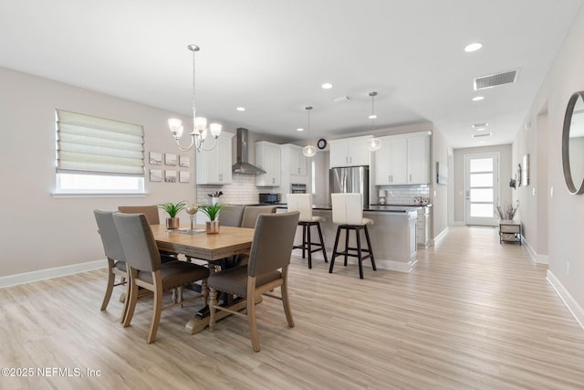 7 Los Lagos Blvd, Palm Coast, FL 32137 - dining area featuring recessed lighting, light wood-style floors, and a chandelier