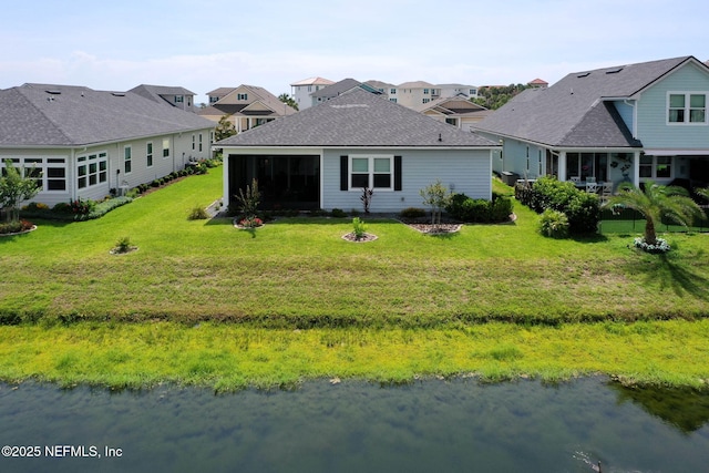 7 Los Lagos Blvd, Palm Coast, FL 32137 - back of property with a sunroom, a yard, a residential view, and a water view