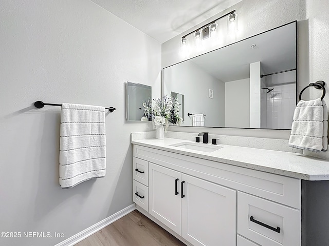 3591 Kernan Blvd S Unit 127, Jacksonville, FL 32224 - bathroom featuring vanity, wood finished floors, and a shower