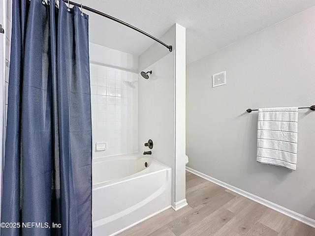 3591 Kernan Blvd S Unit 127, Jacksonville, FL 32224 - bathroom with wood finished floors, shower / bathtub combination with curtain, and a textured ceiling