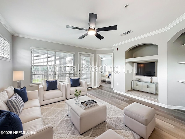 3591 Kernan Blvd S Unit 127, Jacksonville, FL 32224 - living room featuring ceiling fan, wood finished floors, crown molding, and arched walkways
