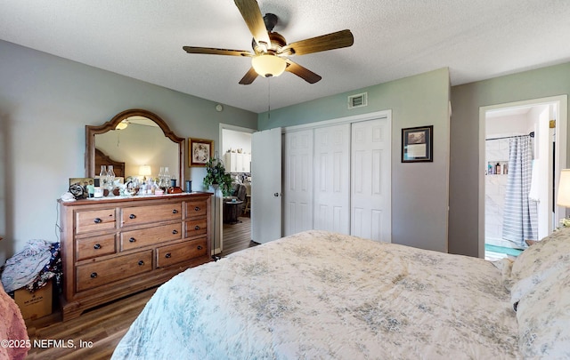 1860 Killarn Cir, Middleburg, FL 32068 - bedroom with wood finished floors, a closet, a ceiling fan, a textured ceiling, and ensuite bathroom
