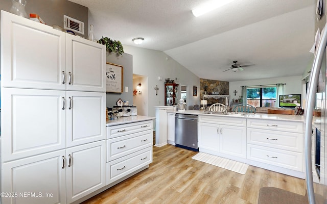 1860 Killarn Cir, Middleburg, FL 32068 - kitchen featuring stainless steel dishwasher, ceiling fan, vaulted ceiling, light wood-style floors, and white cabinets