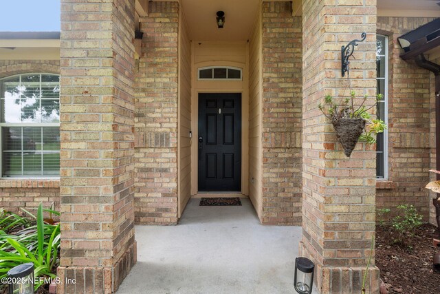 12581 Ashglen Dr N, Jacksonville, FL 32224 - view of exterior entry featuring brick siding