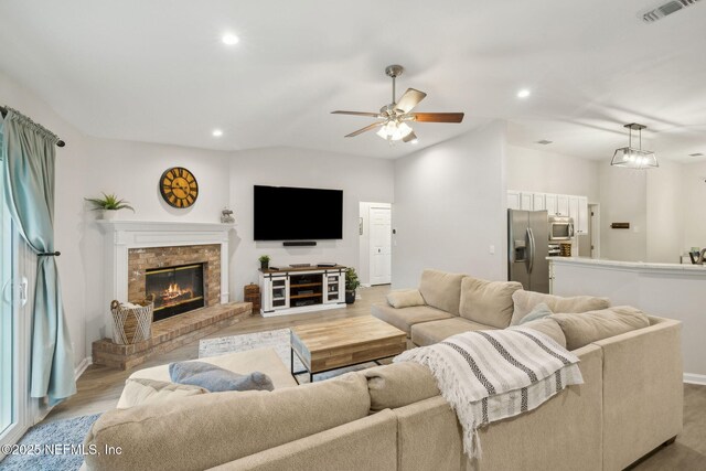 12581 Ashglen Dr N, Jacksonville, FL 32224 - living room featuring a ceiling fan, a fireplace, light wood-type flooring, and recessed lighting