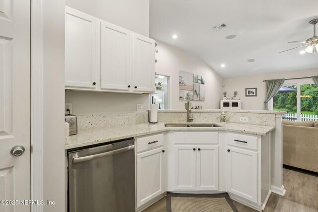 12581 Ashglen Dr N, Jacksonville, FL 32224 - kitchen with stainless steel dishwasher, a peninsula, ceiling fan, open floor plan, and white cabinetry