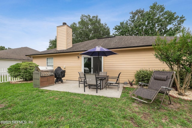 12581 Ashglen Dr N, Jacksonville, FL 32224 - back of property with a patio area, a chimney, and a shingled roof