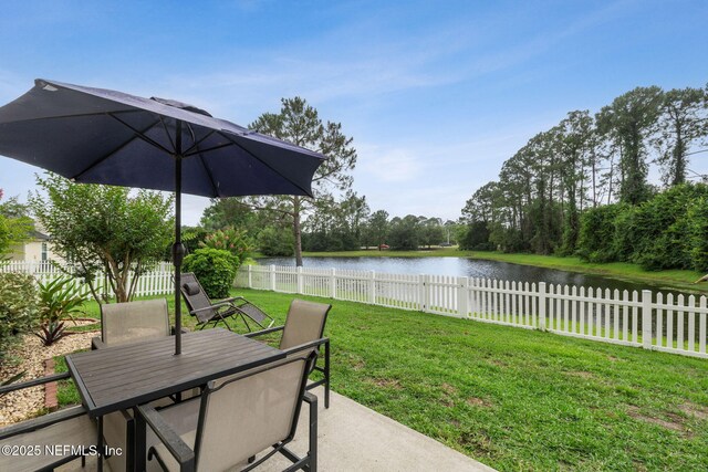 12581 Ashglen Dr N, Jacksonville, FL 32224 - fenced backyard with outdoor dining area, a water view, and a patio area