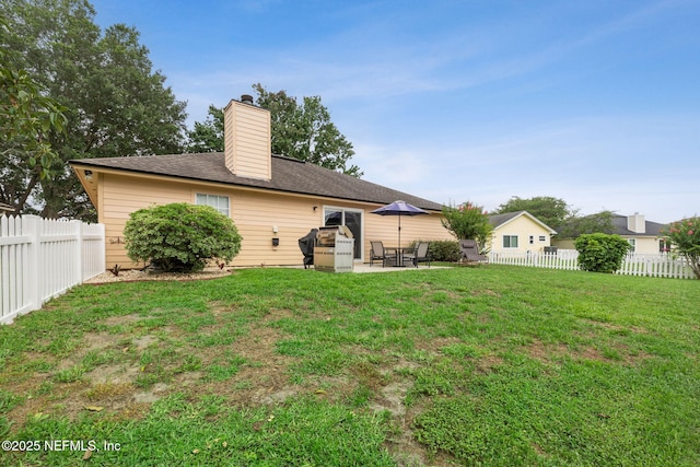 12581 Ashglen Dr N, Jacksonville, FL 32224 - rear view of house featuring a chimney, a patio area, and a fenced backyard