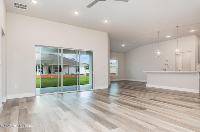 5 Squadron Pl, Palm Coast, FL 32164 - unfurnished living room featuring ceiling fan, light wood-style floors, recessed lighting, a chandelier, and lofted ceiling