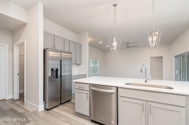 5 Squadron Pl, Palm Coast, FL 32164 - kitchen with stainless steel appliances, a chandelier, light countertops, light wood-style floors, and decorative light fixtures