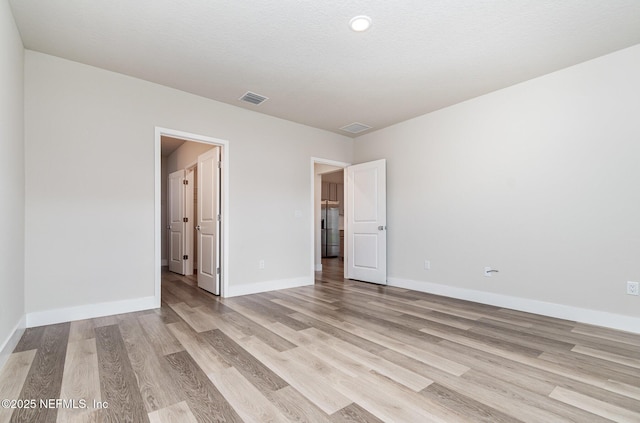 5 Squadron Pl, Palm Coast, FL 32164 - unfurnished bedroom with light wood finished floors and baseboards