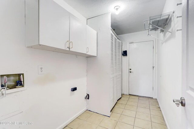 1803 Oakbreeze Ct, Jacksonville Beach, FL 32250 - washroom featuring cabinet space, washer hookup, and light tile patterned floors
