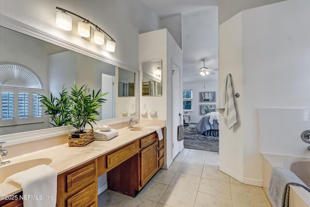 1803 Oakbreeze Ct, Jacksonville Beach, FL 32250 - bathroom featuring ceiling fan, ensuite bath, double vanity, a bathtub, and tile patterned flooring