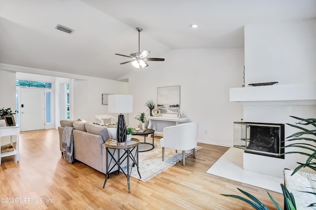 1803 Oakbreeze Ct, Jacksonville Beach, FL 32250 - living room with wood finished floors, lofted ceiling, ceiling fan, and a fireplace with flush hearth