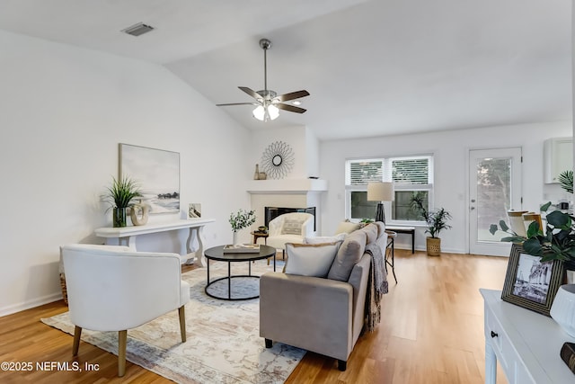 1803 Oakbreeze Ct, Jacksonville Beach, FL 32250 - living room featuring light wood finished floors, a glass covered fireplace, ceiling fan, and lofted ceiling